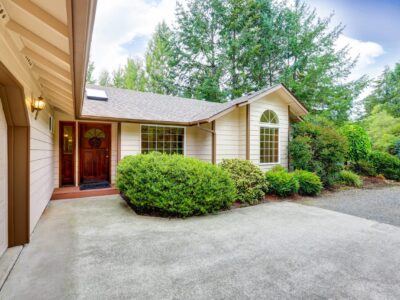 concrete driveway contractor This is an image of a residential property with a concrete driveway.